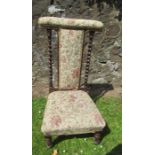 A 19th century Prie Dieu chair, having upholstered back, centre splat and seat, with turned column