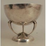 A silver pedestal bowl, the circular bowl with hammered finish raised on three scroll legs to a