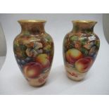 A pair of Royal Worcester vases, decorated all around with hand painted fruit by Higgins and Ayrton,