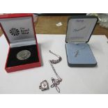 Two crosses on chains, together with a charm formed as a bible and a Royal Mint Diamond Jubilee