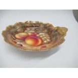 A Royal Worcester circular dish, decorated with hand painted fruit to a gilt scallop handle, by