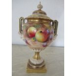 A Royal Worcester covered vase on a pedestal, decorated half round with hand painted fruit by