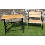A garden chair, with black frame and wooden slates, together with a similar garden table with
