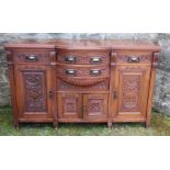 An Edwardian mahogany sideboard, fitted with cupboards and drawers, with carved decoration, 38ins
