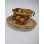 A Royal Worcester tea cup and saucer, decorated all around with hand painted fruit by Freeman -