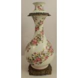 A Victorian opaline glass vase, of baluster form, with gilt metal mounts and decorated with flowers,