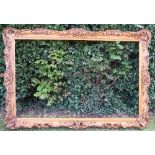 A large gilt picture frame, with shell, scroll, leaf and flower decoration, aperture size 55ins x