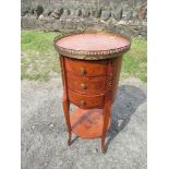 A kingwood French style circular chest of drawers, raised on slender legs, with gilt mounts,