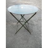 A painted folding garden table, diameter 29ins