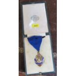 A cased silver gilt and enamel Wholesale Tobacco Dealers Association Medal, on a ribbon