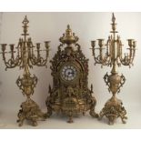 A 20th century gilt metal clock garniture, the clock with striking movement, having an ornate
