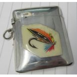 A white metal vesta case, decorated with a panel of fishing flies