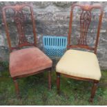 A pair of mahogany inlaid chairs, with pierced splats, stuff over seta, on front reeded supports