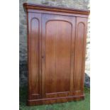 A Victorian single door wardrobe, opening to reveal compartments with hanging space, four sliding