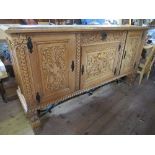 A large continental style oak sideboard,  having parquetry and cross banded top, over cupboard