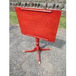 A red painted reading stand, with adjustable top, raised on reeded column