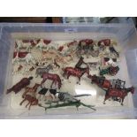 A collection of Britain's farmyard animal models, predominantly cows, including model plough