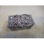 A hallmarked silver pill box, of rectangular form, embossed with cherubs and scrolls, 1.75ins x