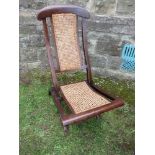 A rosewood framed folding chair, with caned back and seat