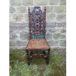 An Antique carved hall chair with caned seat