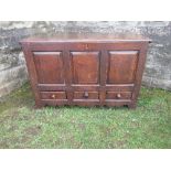 An Antique mule chest, having a rising lid. over three fielded panels, over three short drawers,