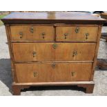 An 18th century walnut chest, of two short over two long drawers, with feather edge banding, 38ins x
