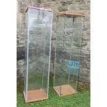 Two rectangular glass display cabinets, opening to reveal glazed shelves, height 64ins x width 17ins