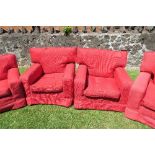 A pair of red upholstered armchairs, no fire labels
