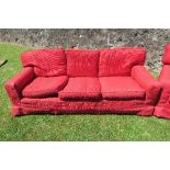 A red three seater settee, no fire labels, width 85ins, height 29ins, depth 35ins