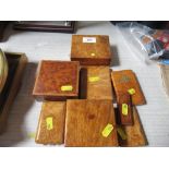 A collection of burr wood boxes, to include three square boxes and five others