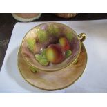 A Royal Worcester cup and saucer, the interior of the cup and the saucer decorated with fruit to a