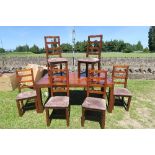 A modern stained pine dining table, 71ins x 39ins, height 31ins, together with six matching dining