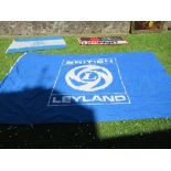 Two British Leyland flags, 48ins x 67ins and 90ins x 147ins, together with a Unipart flag, 32ins x