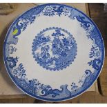 A large circular plate, decorated in printed blue and white, diameter 16.5ins