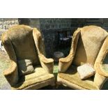 A pair of wing back armchairs, in gold fabric, raised on short cabriole legs