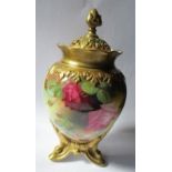 A Royal Worcester covered vase, having a pierced gilt cover, the body decorated with roses, raised