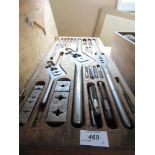 A cased set of tools for drill bits, together with a box containing knobs, handles, etc.