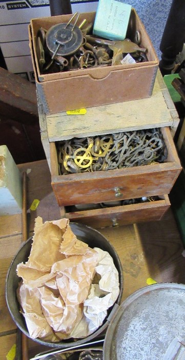 A small chest of three drawers, containing hinges, mounts, clock keys, a tin of gilt handles etc