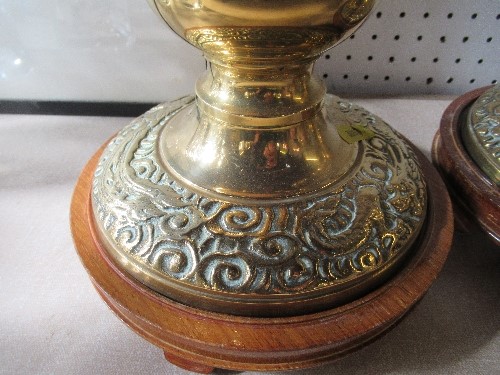 A pair of brass lamp bases, with multi knop stems, and the bases decorated with dragons, on wooden - Image 2 of 3