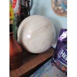 A large turned white stone ball