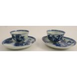 Two Nanking Cargo porcelain tea bowls and saucers, decorated in blue and white with buildings in