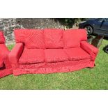 A red three seater settee, no fire labels, width 85ins, height 29ins, depth 35ins