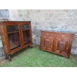 An oak sideboard, with carved base, fitted with two drawers over two doors, having carved foliate