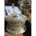 A silver plated oval biscuit barrel, with embossed decoration, together with two decanters