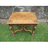 An 18th century design walnut coffee table, the ornately carved legs united by a cross stretcher