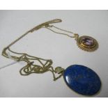 An amethyst pendant on a chain, together with a lapis lazuli 9 carat gold pendant, on a metal chain