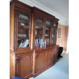 A 19th century mahogany break front bookcase, with four glazed bookcases to the upper section and