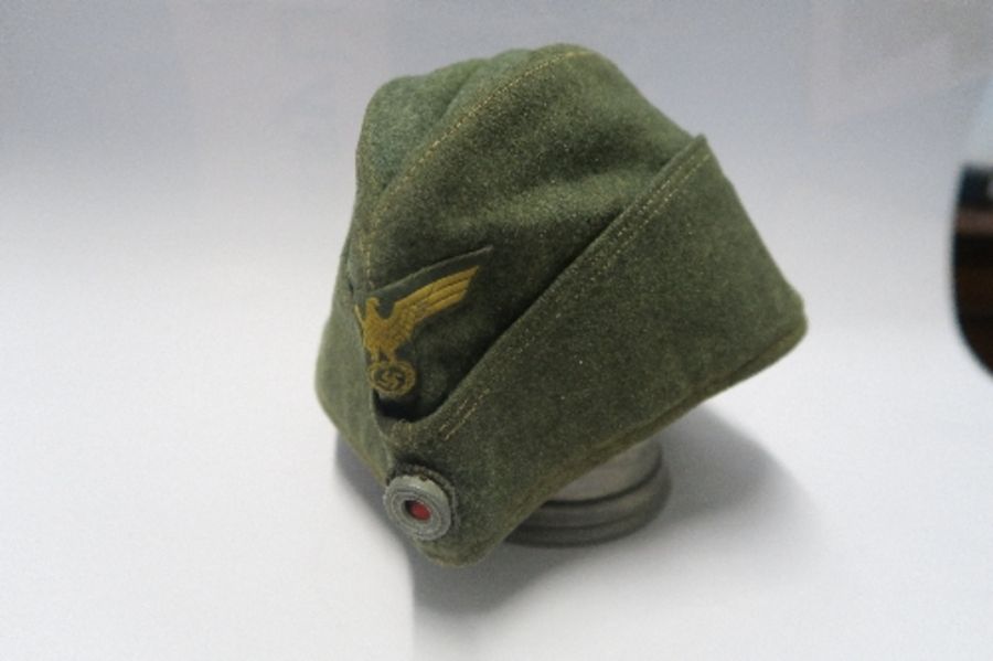 A Third Reich style M38 side hat, in grey wool fabric, having appliqued white RMBO motif to the - Image 17 of 19