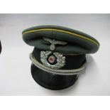 A Third Reich style visor cap, in green wool fabric, with yellow piping and dark green felt hat