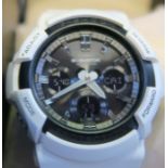 A Casio G-Shock wrist watch in white, with case